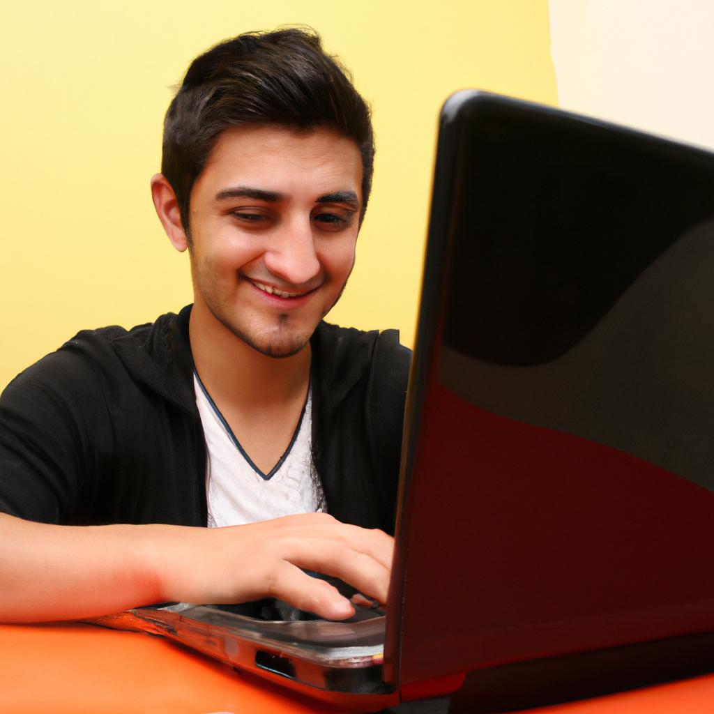 Person typing on laptop, smiling
